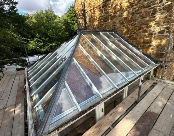 A glass lantern roof, with leadwork to the ridge and hips.