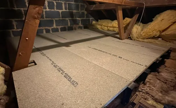 A loft boarded out on raised legs over new insulation.