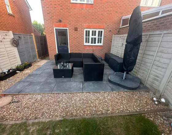 Old decking removed and a patio laid in its place.